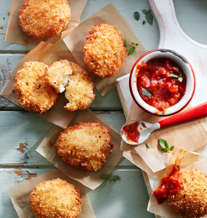 Crunchy Yogurt Bites on a pickick table with a wood cutting board with salsa and a spoon on top.