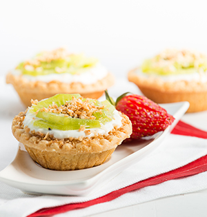 Coconut Tarts made with Astro yogurt served with strawberries on the side