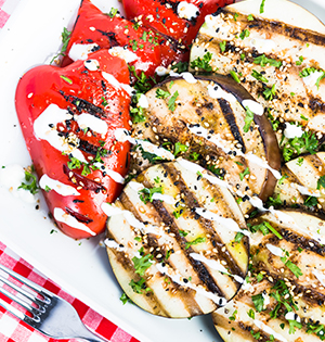 Grilled Vegetable Marinade made with Astro yogurt used for grilled eggplant and red peppers servedon a white platter