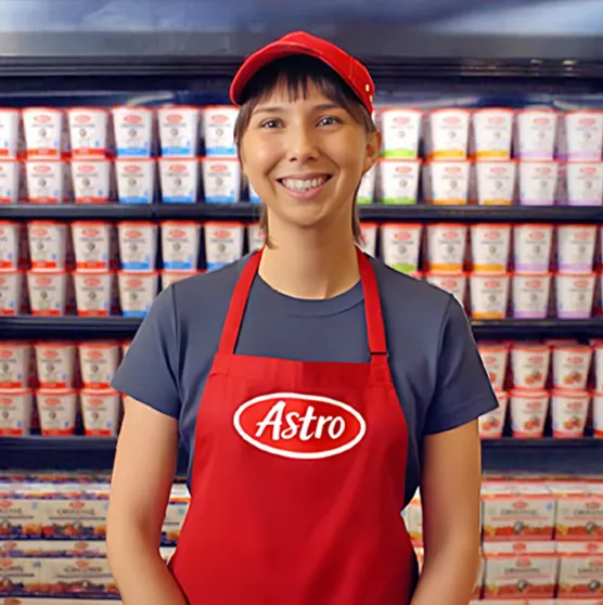 Woman standing infront of a display of Astro yogurt